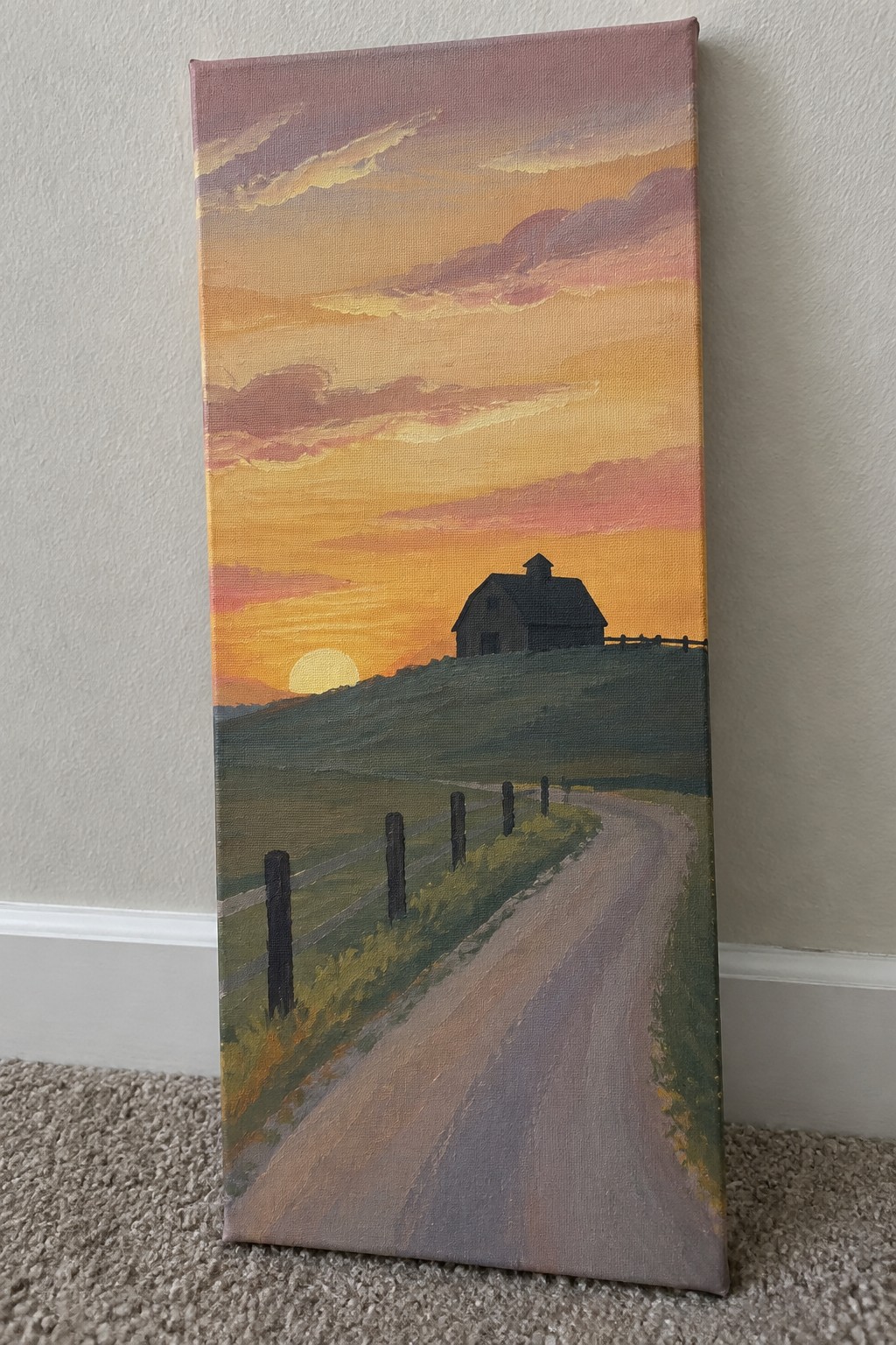 Sunset painting with barn on hill, curving road, fences, and pink-orange sky.