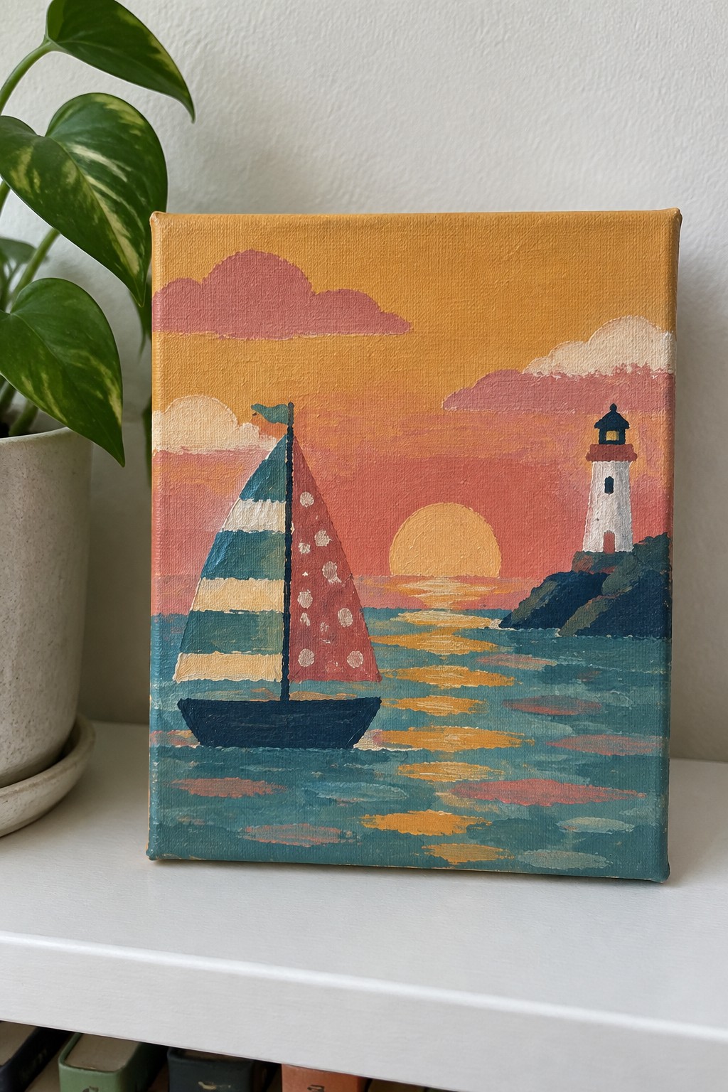 Colorful painting of red-sailed boat and white lighthouse at orange sunset