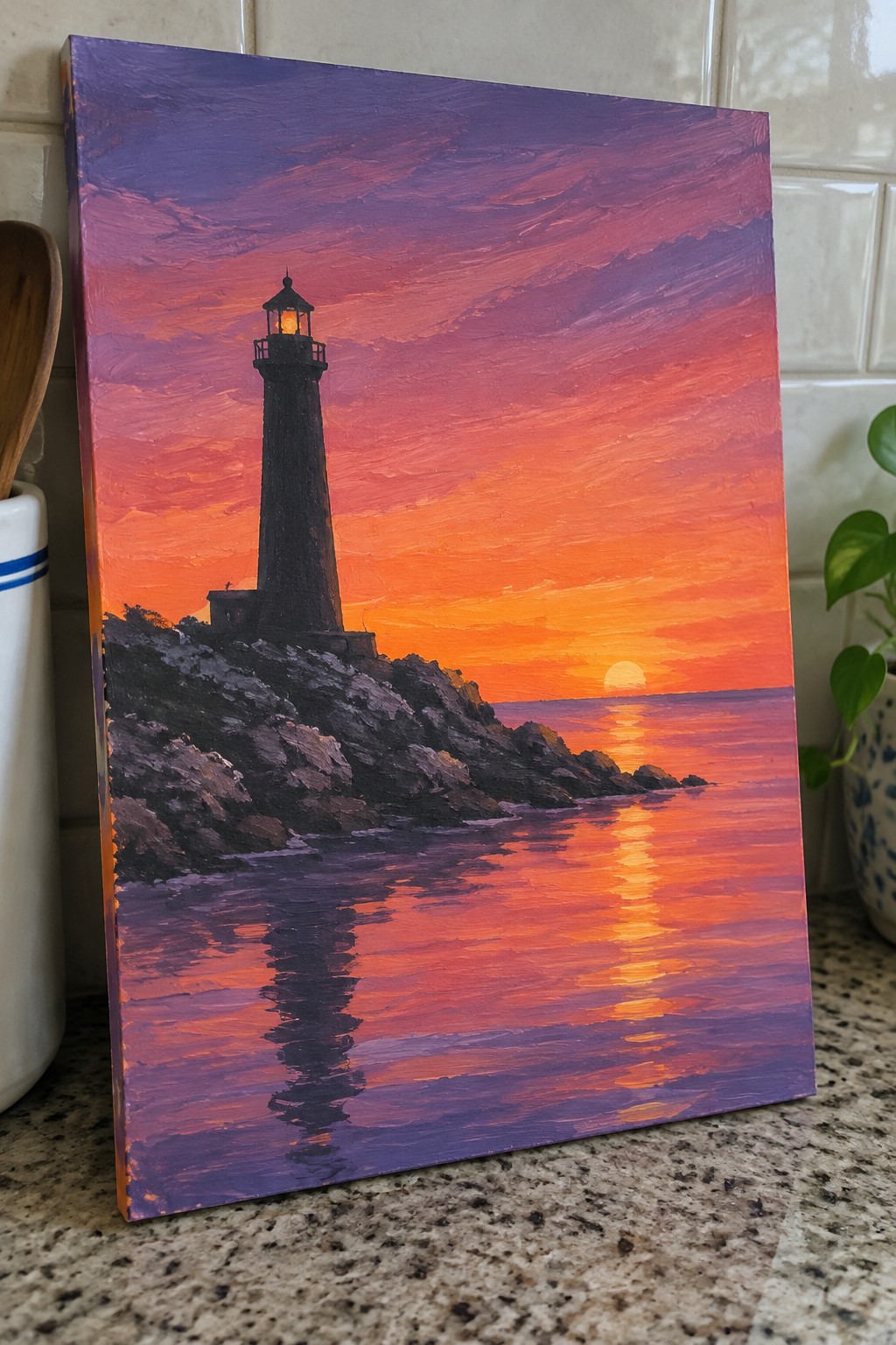 Vibrant sunset painting of black lighthouse on rocks with orange-purple sky reflecting in water