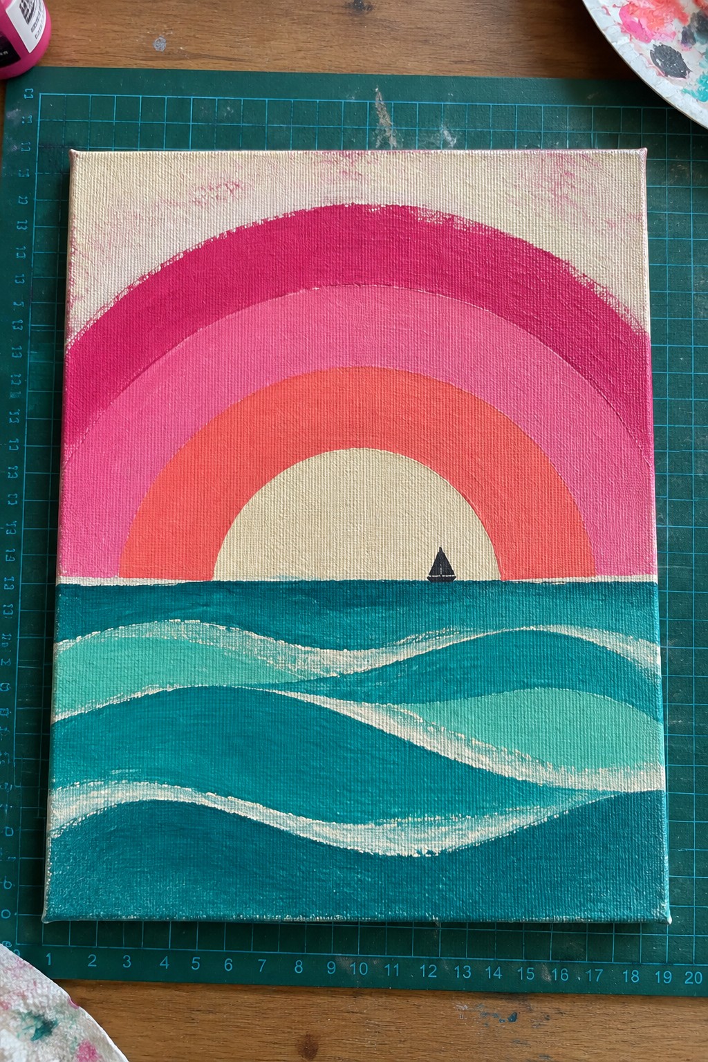 Vibrant canvas painting with pink-orange arches, beige sun, and sailboat on teal waves