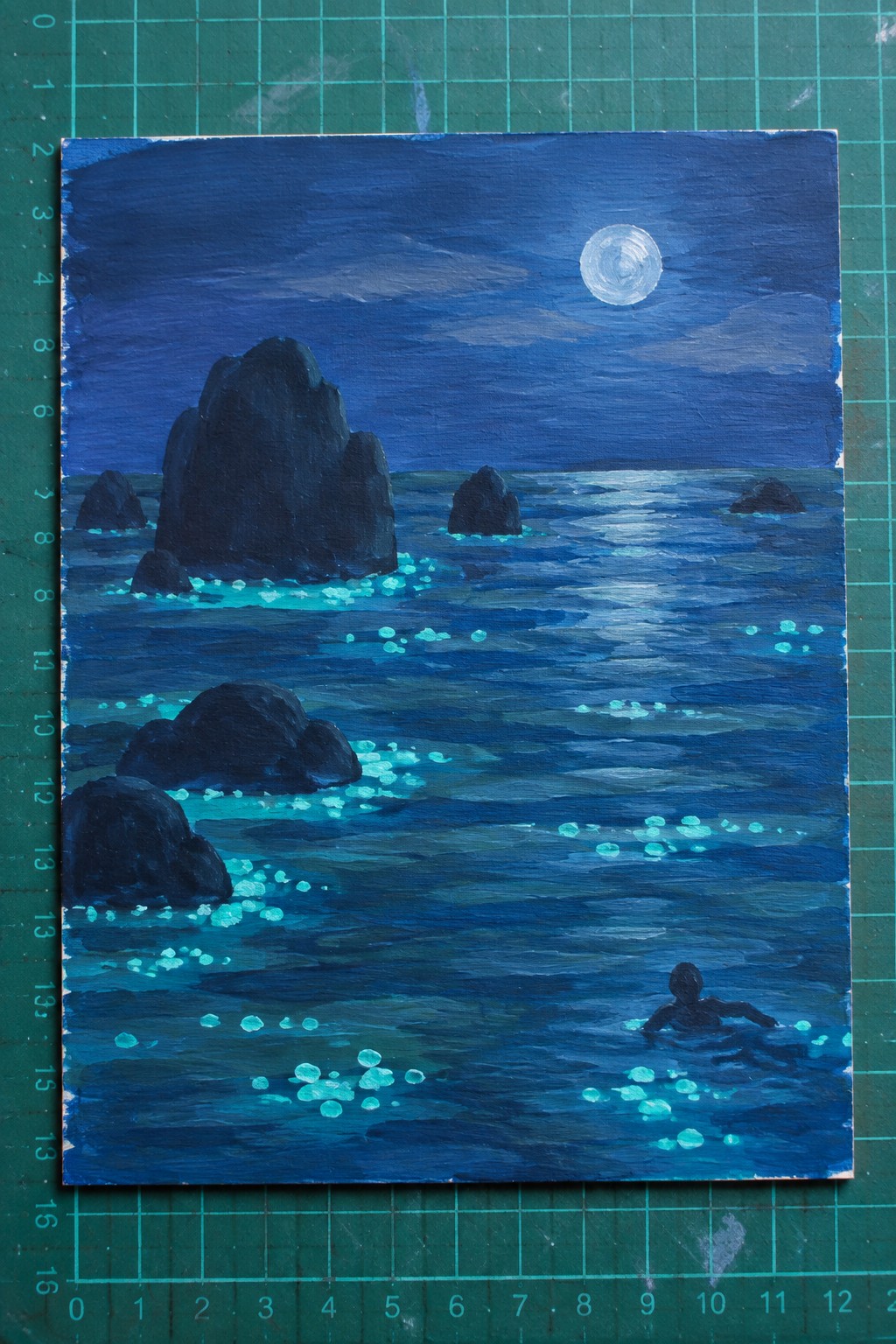 Moonlit seascape painting with dark rocks, glowing turquoise water, and lone swimmer at night.