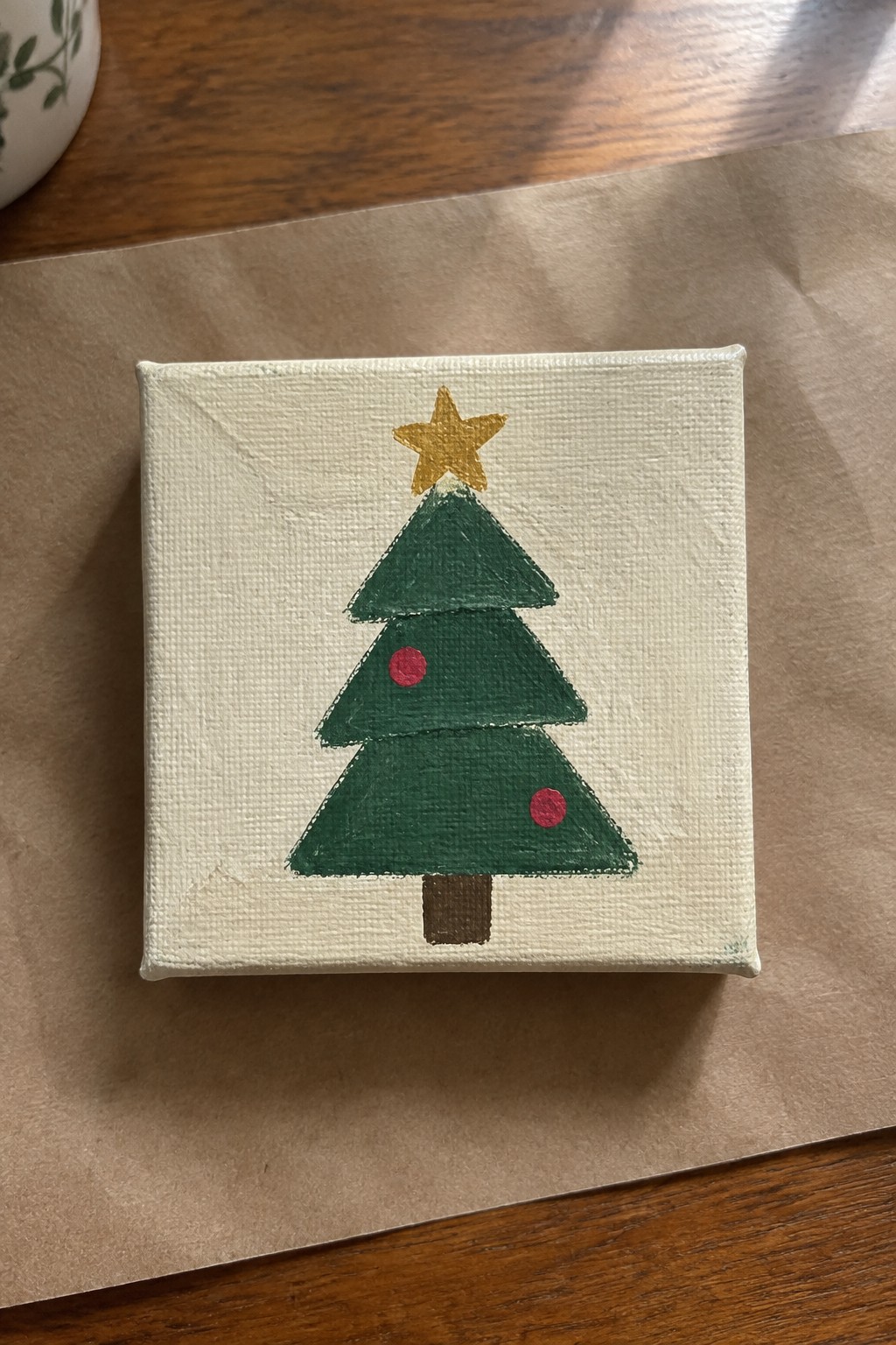 Small square canvas with green Christmas tree, yellow star, red ornaments, and brown trunk