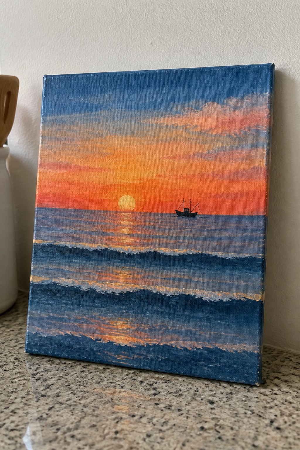 Canvas painting of sunset over blue ocean waves with silhouetted boat