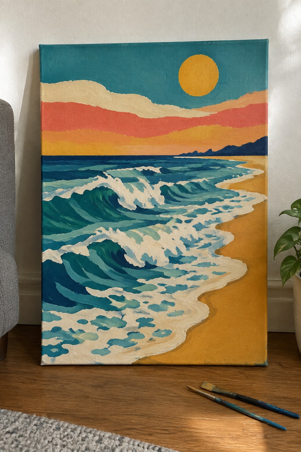 Colorful acrylic painting of crashing teal waves on golden beach with sunset sky and paintbrushes