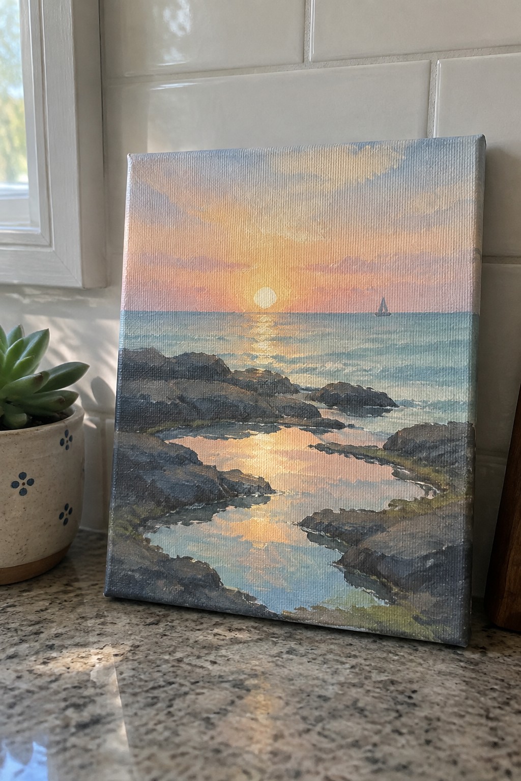 An acrylic painting of a sunset over the ocean showing rocks, reflective water pools, and a distant sailboat on the horizon.