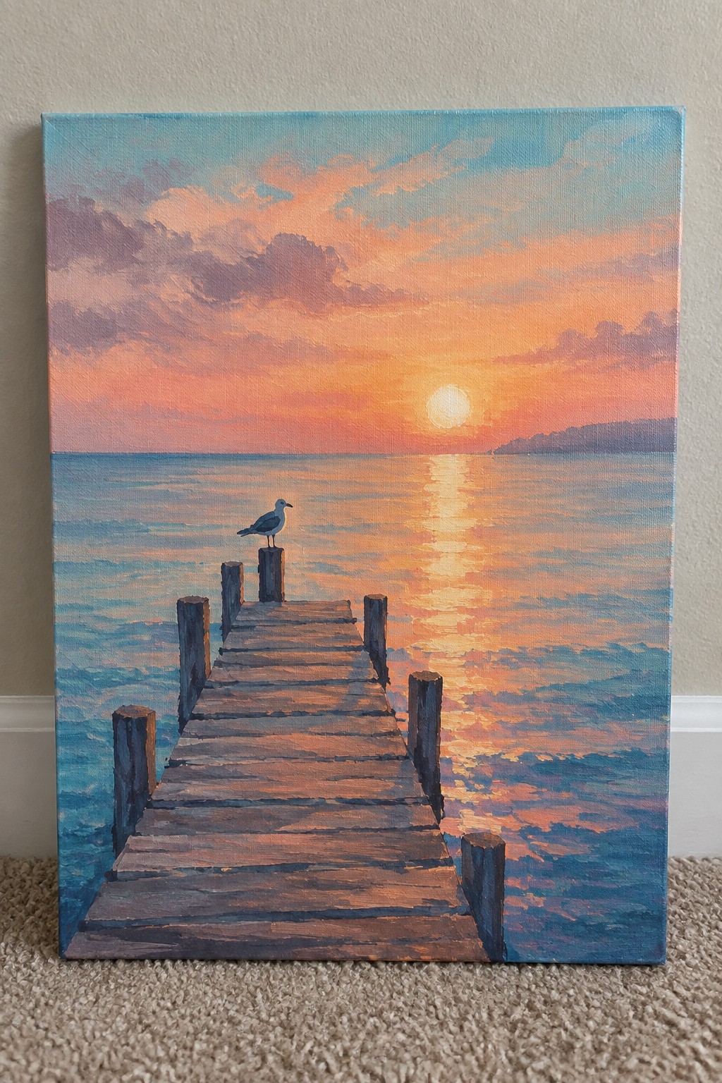 Wooden pier at sunset with seagull on post, orange-pink sky, and sunlit water.