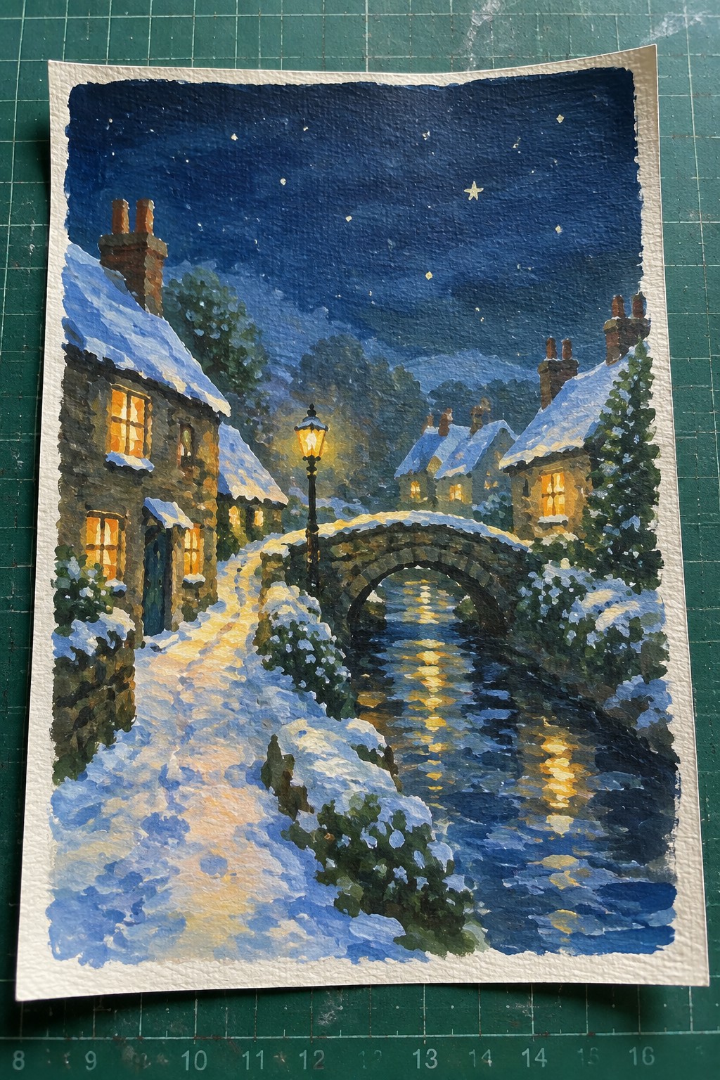 Watercolor of snowy village with stone bridge, glowing windows, and starry night sky