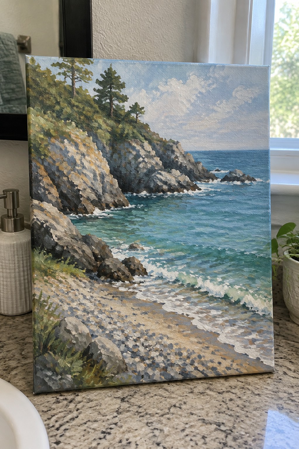 Oil painting of rocky cliffs, trees, and turquoise waves on granite countertop