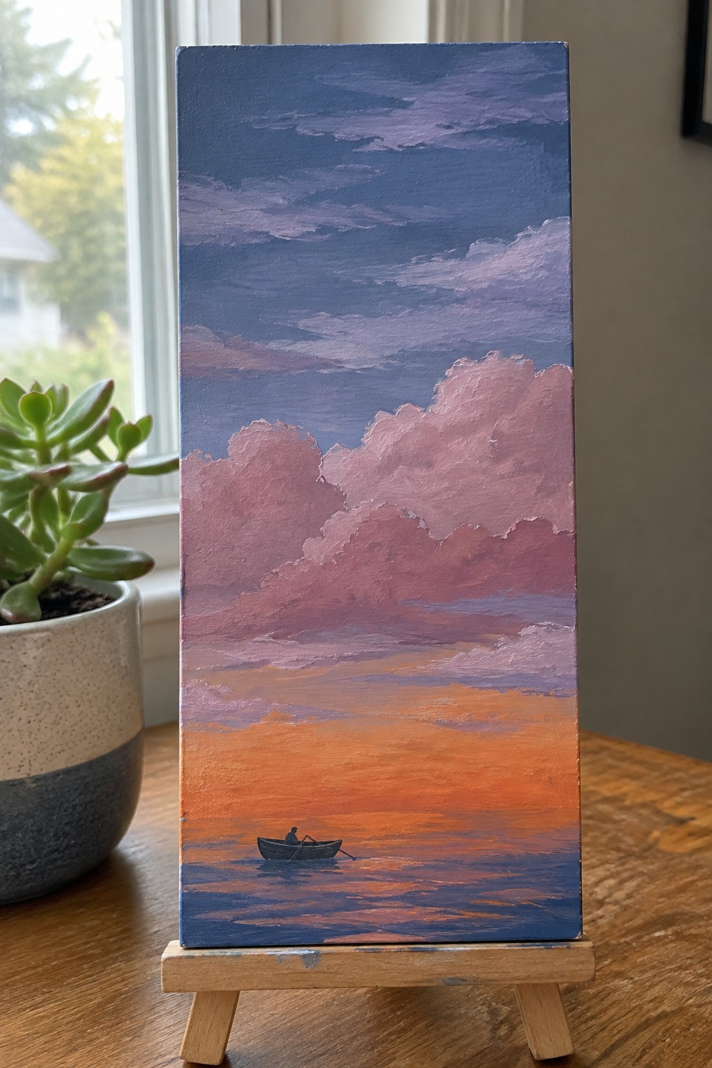 Tall canvas painting of solitary rower in boat on orange-pink sunset sea with clouds.
