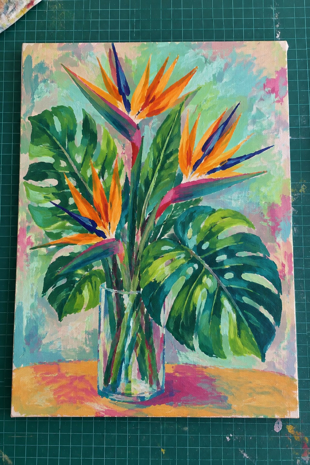 Vibrant painting of bird of paradise flowers and monstera leaves in glass vase