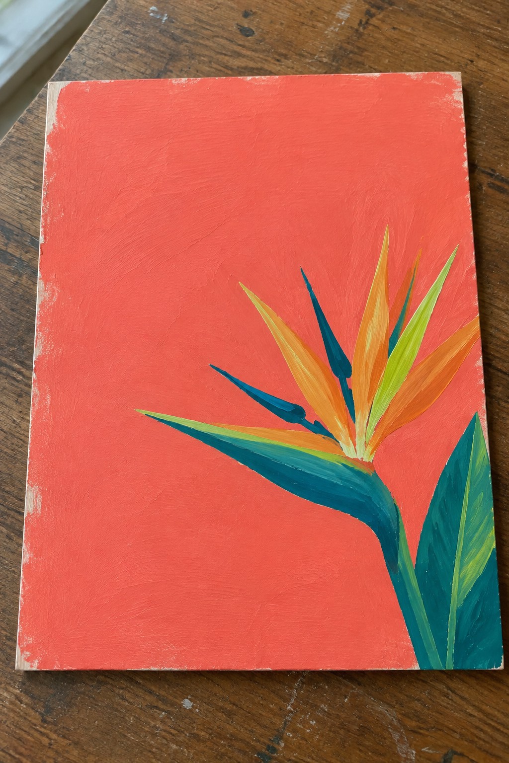 Orange and blue bird of paradise flower on bright red canvas