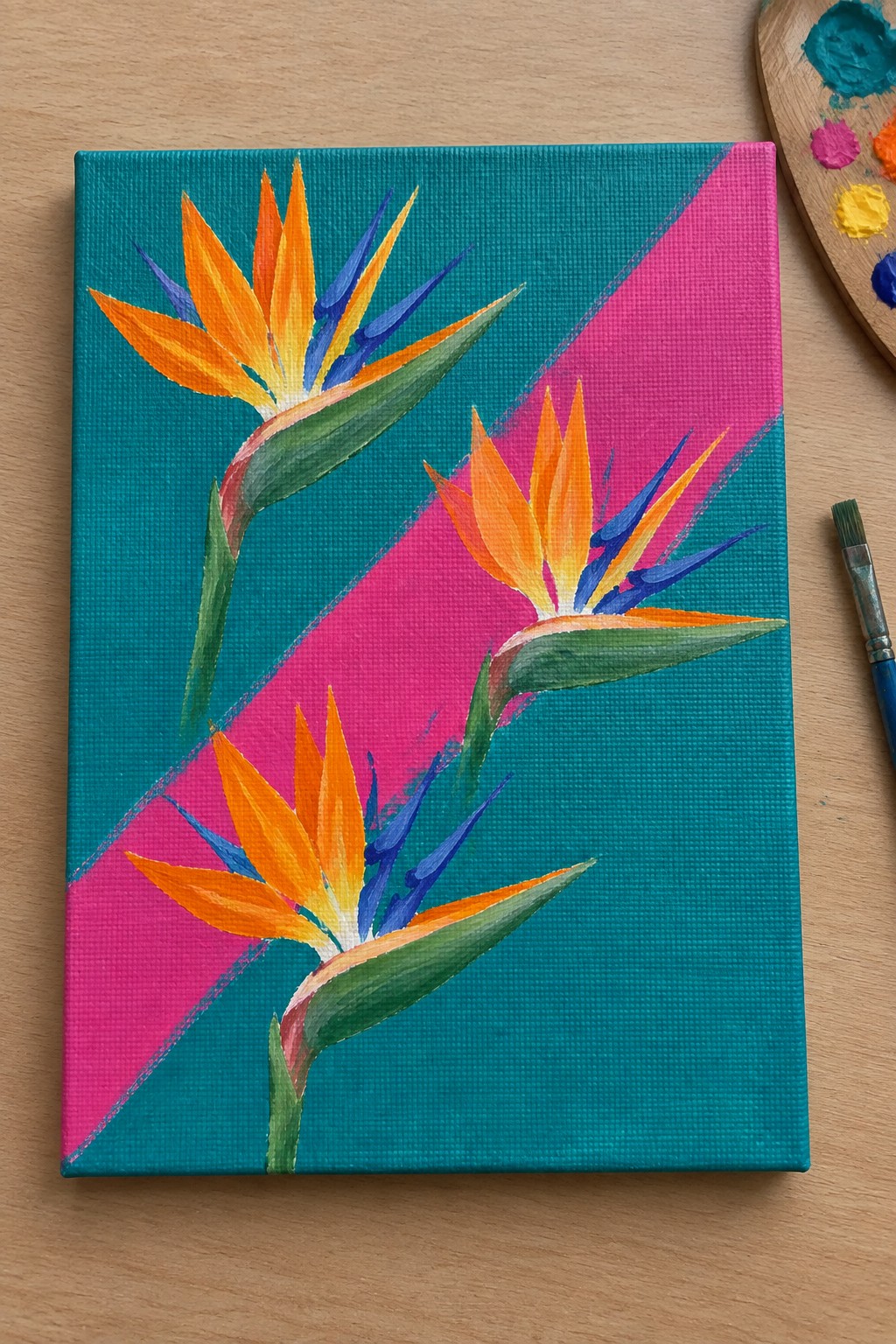 Three vibrant bird of paradise flowers on teal and pink canvas with palette