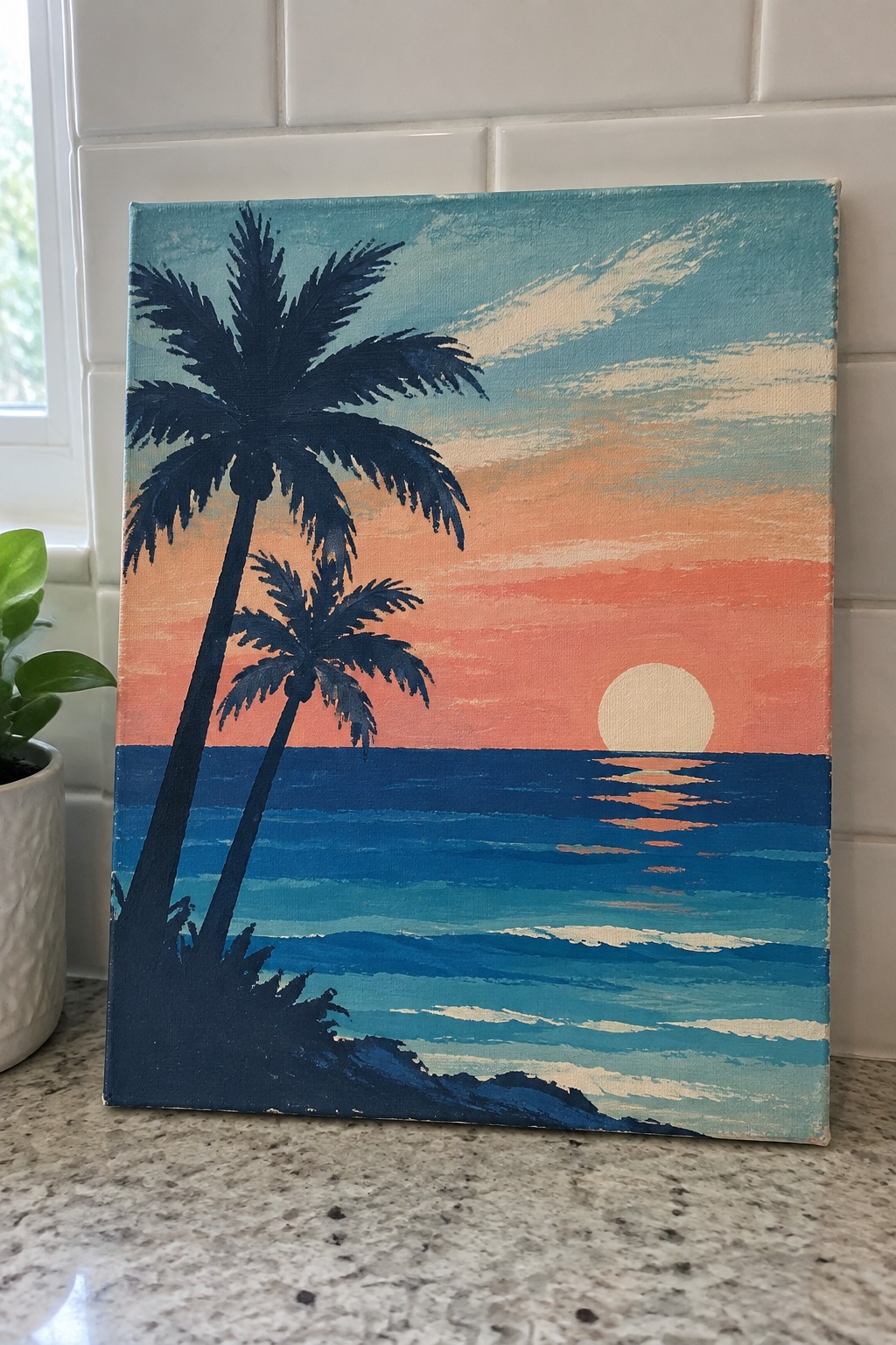 Canvas painting of palm silhouettes against orange sunset over blue ocean waves.