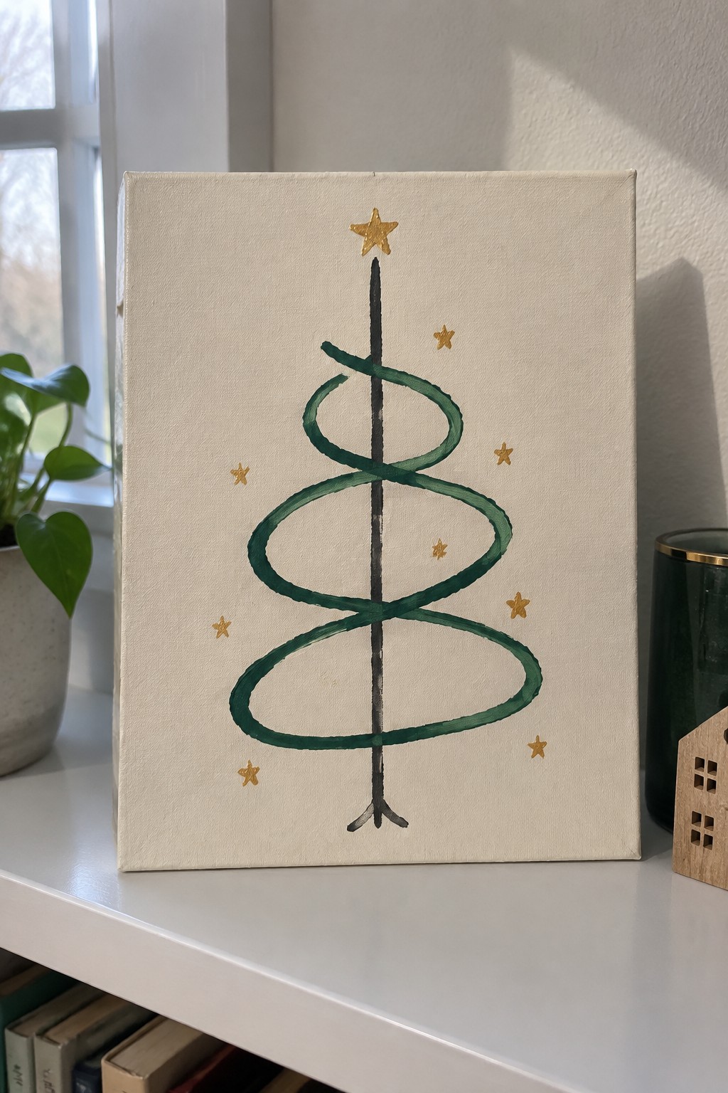 Abstract canvas painting of spiraled green Christmas tree with gold stars