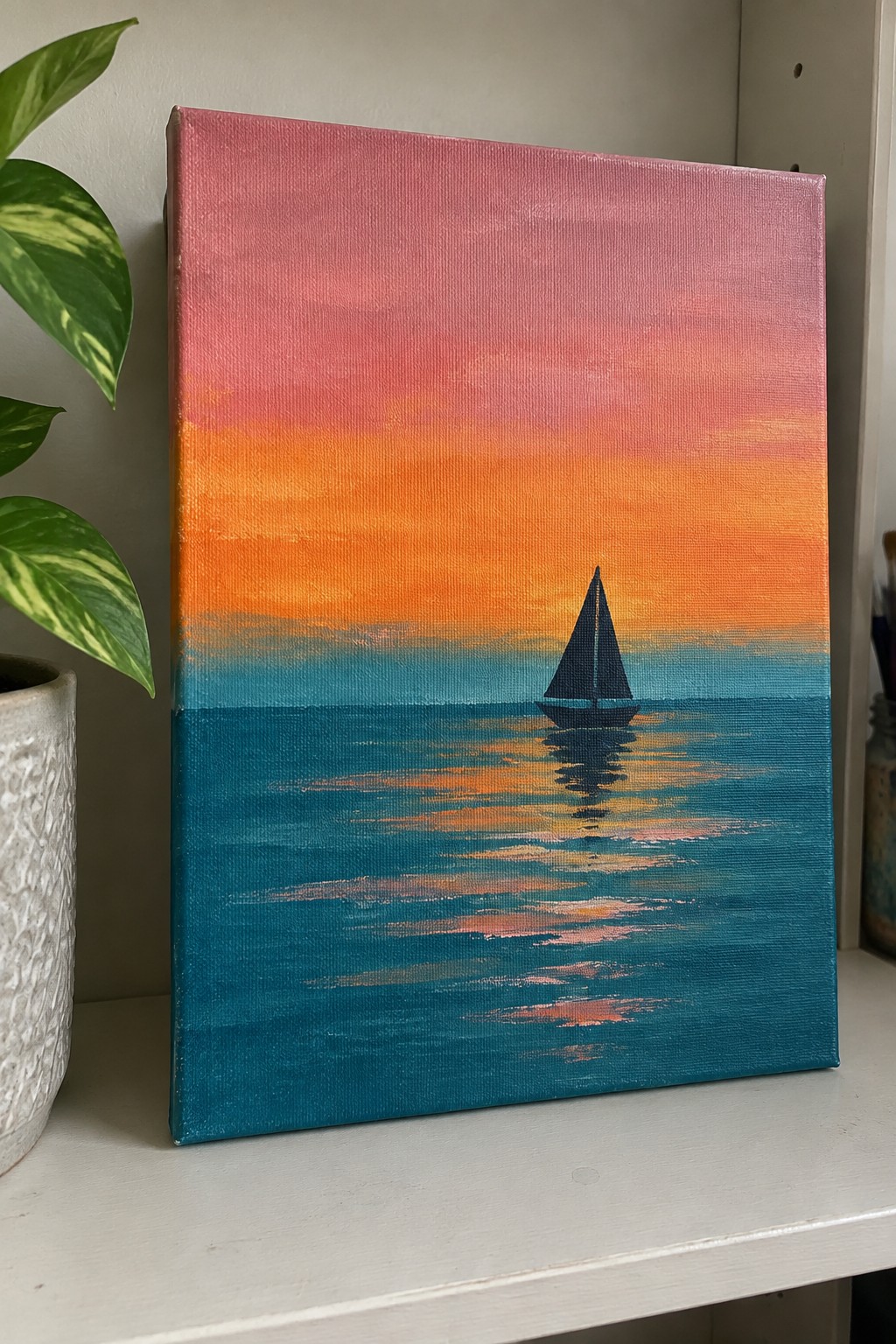 An acrylic painting of a dark sailboat silhouette on teal water with a pink-to-orange-to-blue sunset gradient sky and soft reflections.