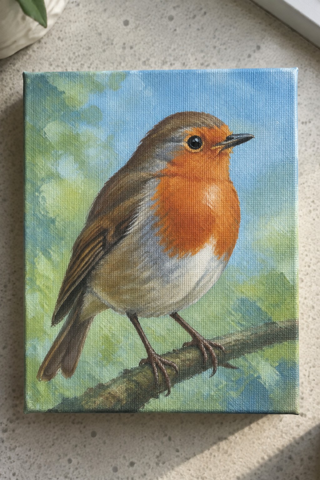 Colorful painting of robin with orange breast perched on branch against blue sky