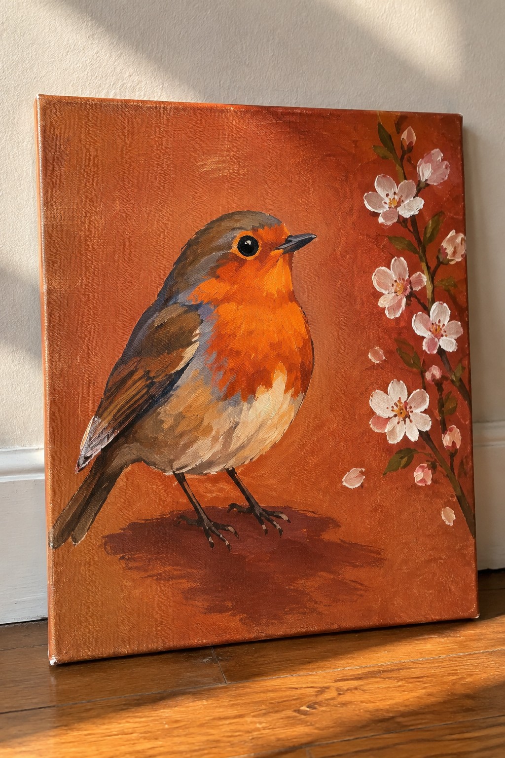 Robin painting with orange breast on textured red background beside pink cherry blossoms