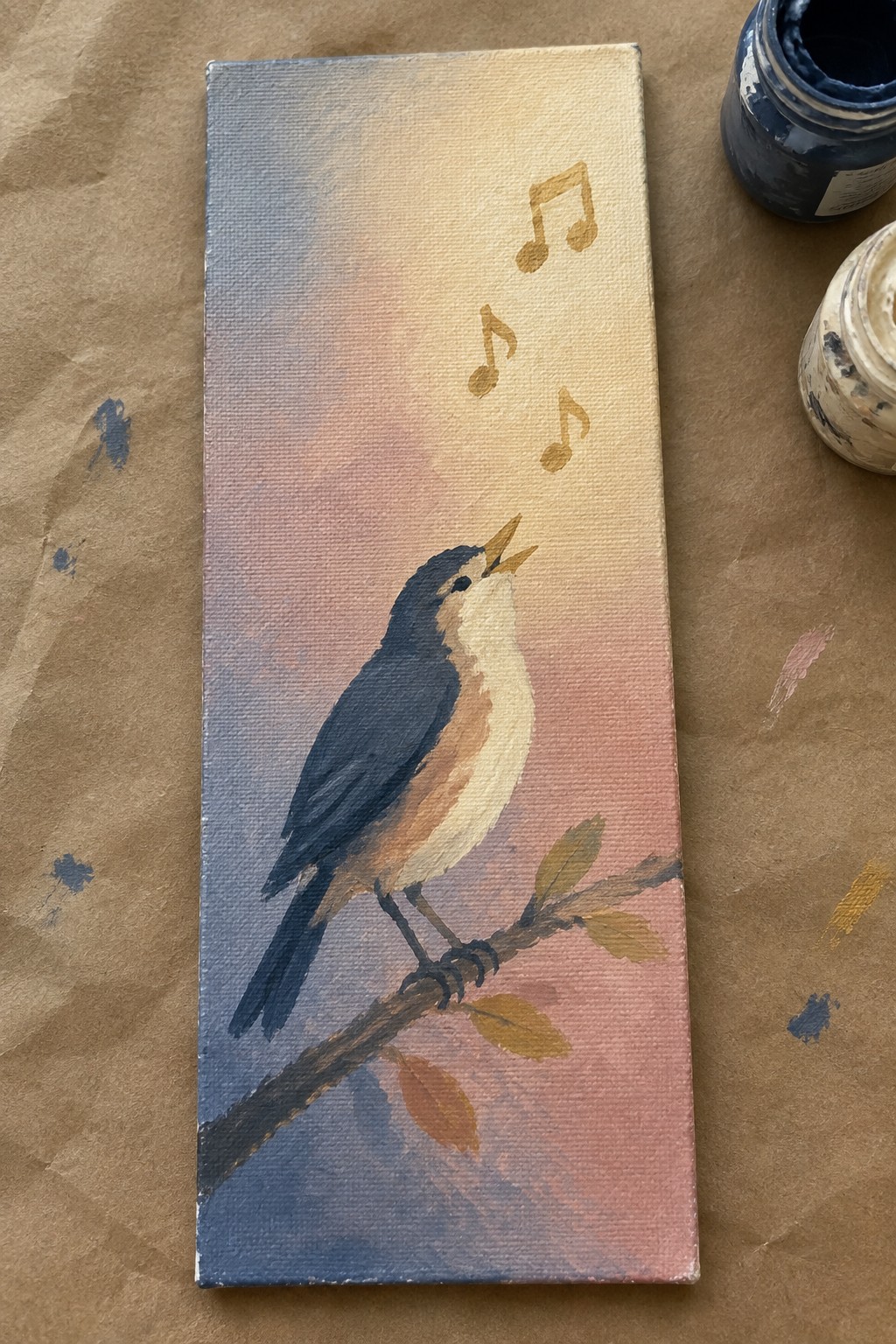 Canvas painting of bird on branch with floating notes, paint jars beside it