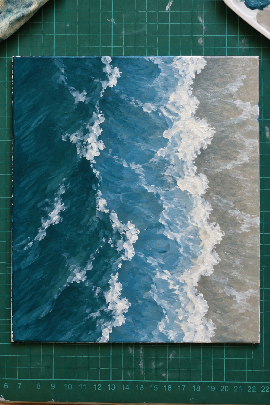 Impressionistic painting of dark blue waves with white foam on canvas