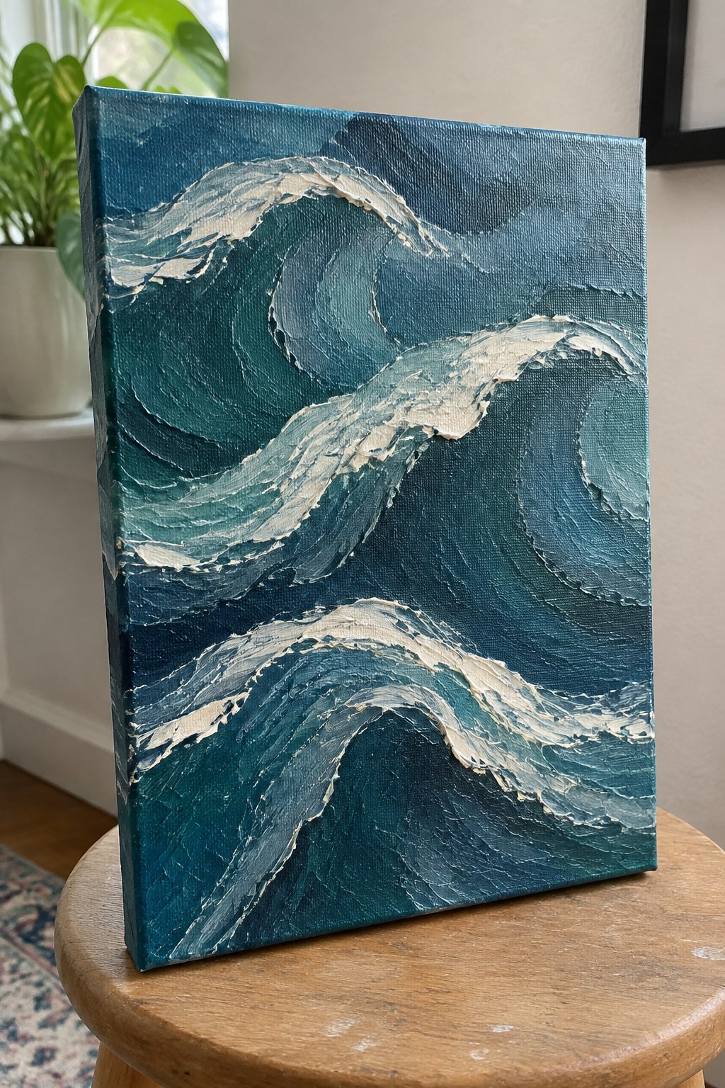 Thickly textured blue wave painting with white foam on wooden stool