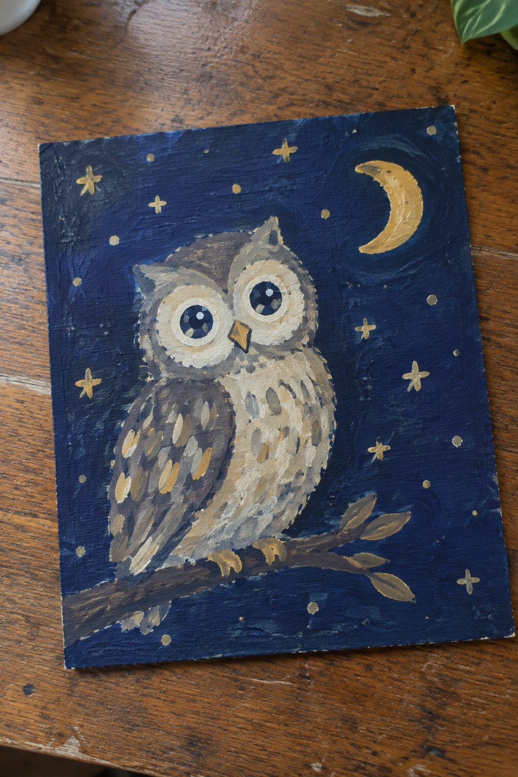 Owl painting with big eyes perched on branch under starry night sky with moon