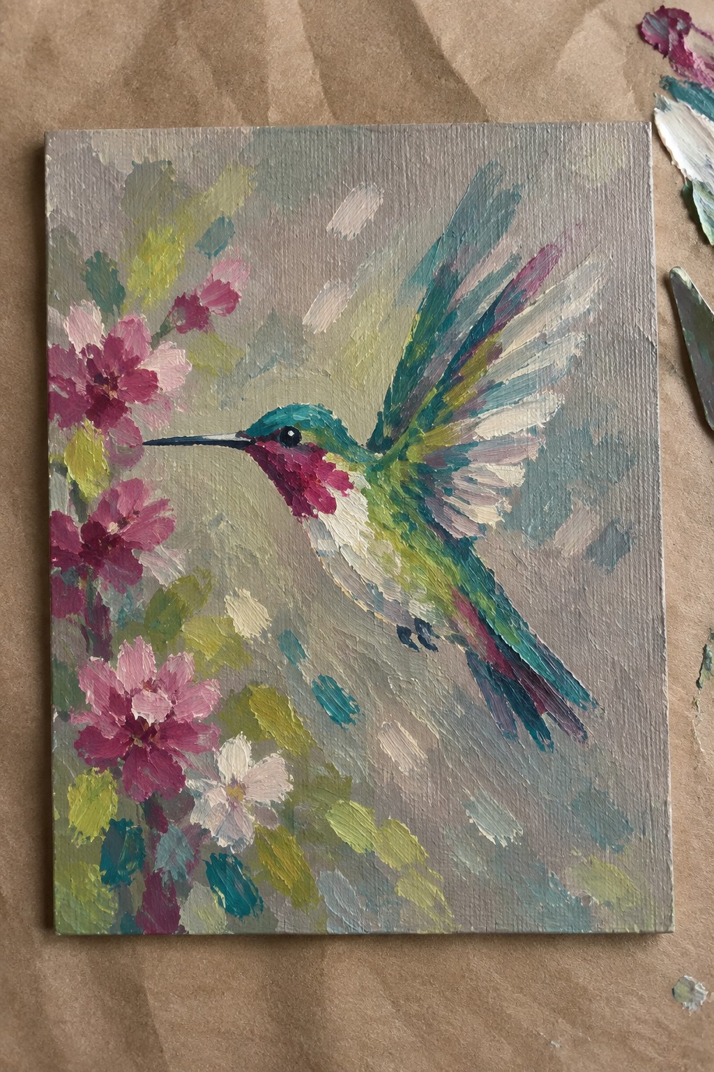 Vibrant hummingbird with teal wings hovering near pink flowers on textured canvas