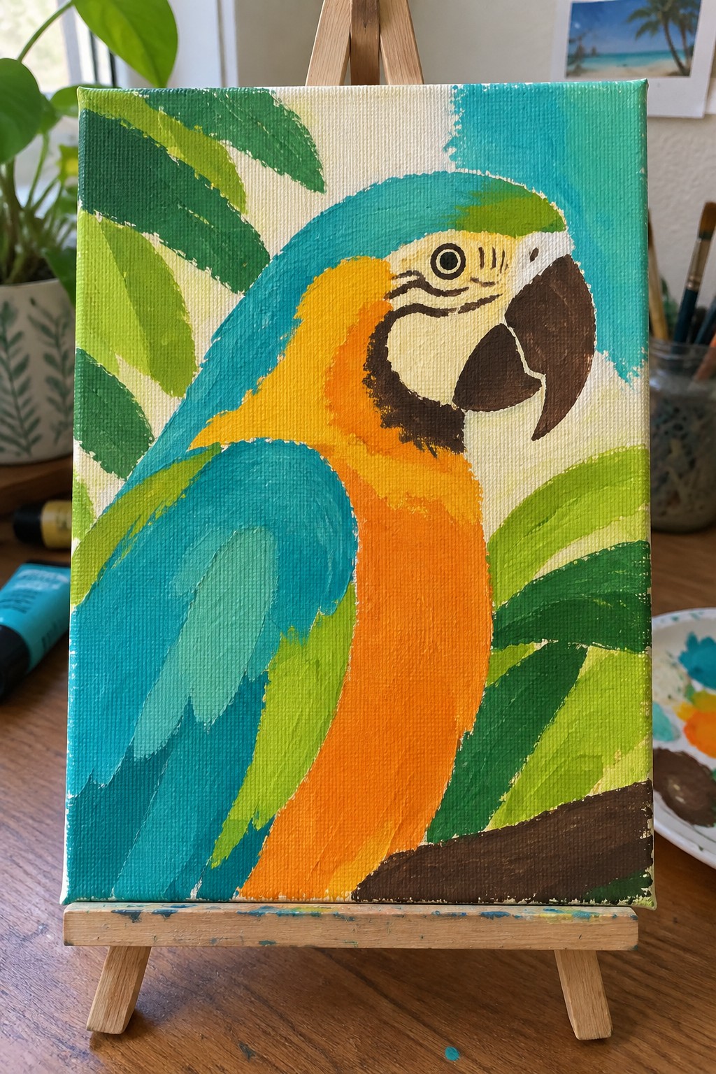 Vibrant macaw parrot painting on canvas atop wooden easel in studio